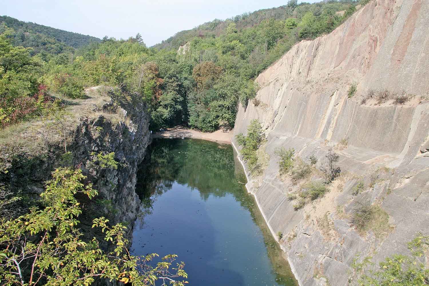 Prokopské Quarry Lake enclosed by limestone cliffs